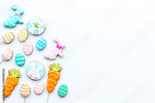Sweets, pastry for Easter table. Easter eggs and Easter bunny concept. White background top view copy space
