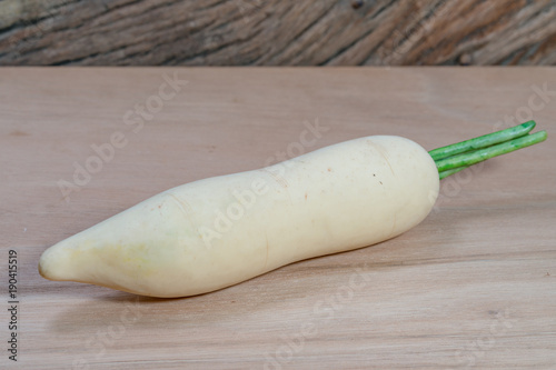white radish (plastic) isolated on wooden floor