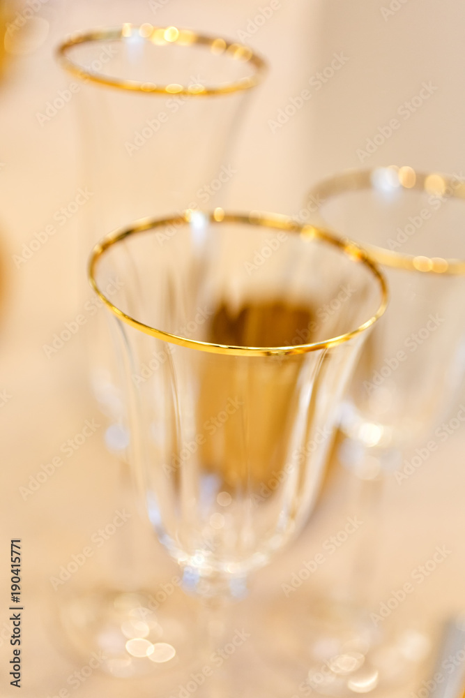 Festive tableware on the table. A table is set for dinner. beautiful, exquisite dishes. Beautiful Crystal Holiday Glasses Festive tableware on the table. A table is set for dinner. beautiful, exquisite dishes. Beautiful Crystal Holiday Glasses