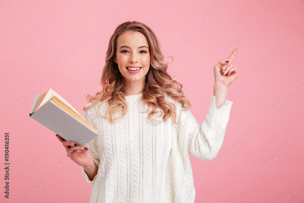 Happy lady reading book over pink background Happy lady reading book over pink background