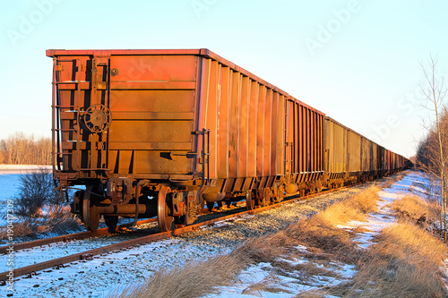 A train sitting on a track with golden sunlight on it