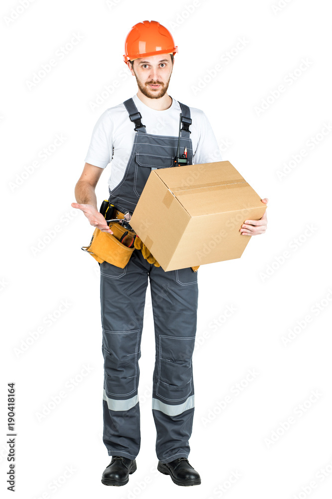 A man is a builder with a cardboard box in his hands. Isolated over white background. A man is a builder with a cardboard box in his hands. Isolated over white background.