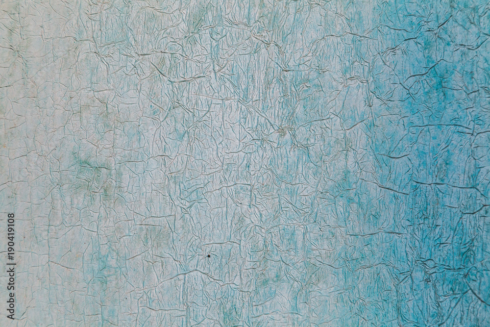 Texture of peeling paint on wall with white and blue gradient