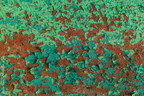 Rusty red metal wall weth peeling flakes of lime green paint texture. loft artwork © vickyrandom
