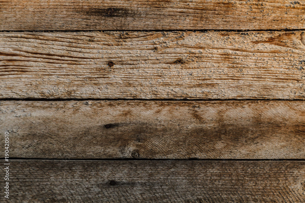 Texture of old rough unpolished wood with marks cracks and scratches Texture of old rough unpolished wood with marks cracks and scratches