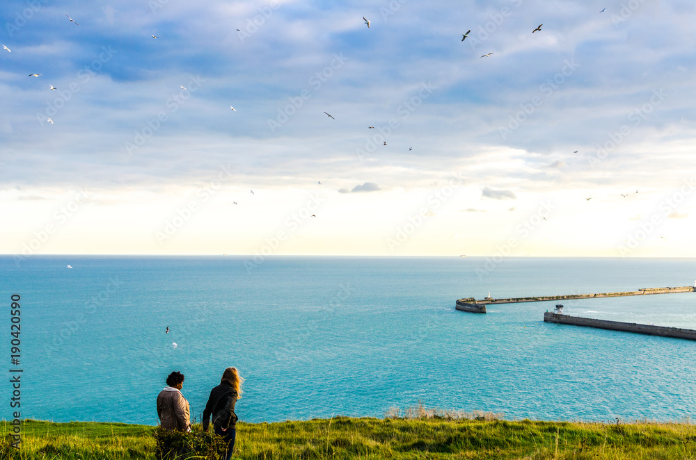 Naklejka premium Evening walk at the White Cliffs of Dover overlooking the port by the English Channel