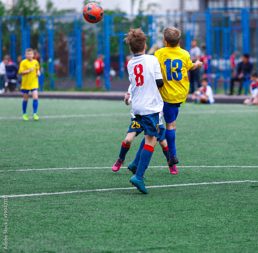Fototapeta premium kids play football tournament and enjoy their game on the stadium