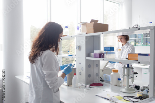 Wallpaper Mural Women standing and working in lab Torontodigital.ca