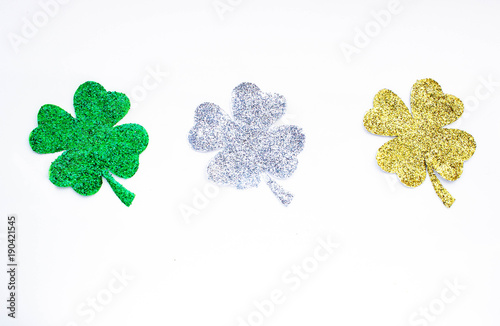 Golden, green and silver clover leaf isolated on white background. St. Patrick day concept.