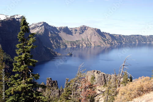 A view of Phantom Ship Island in the blue water of the lake in the Crater Lake National Park in a sunny day, Oregon, USA