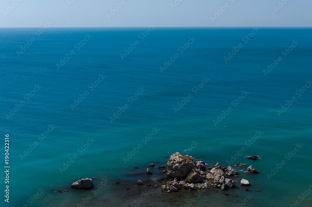 Beautiful panoramic natural view of the sea. From the height of bird flight. Blue and turquoise water of Black sea coast in Sudak, Crimea.