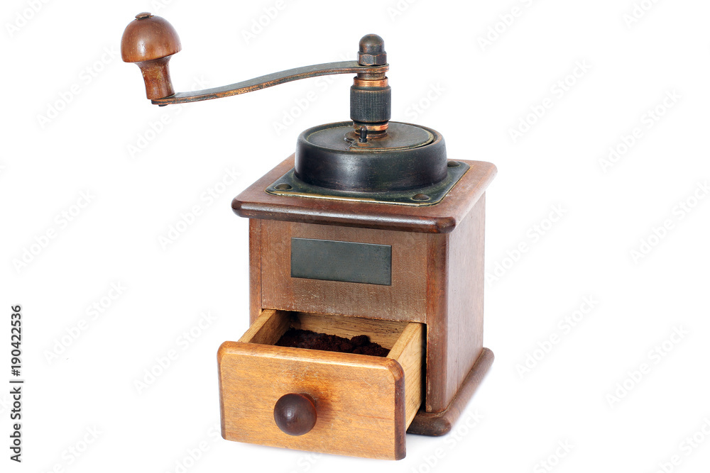 Manual coffee grinder on a white background. Antiquary. Retro. Old things. Coffee