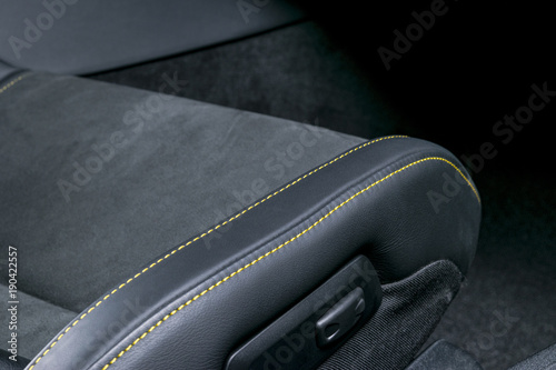 Modern Luxury car inside. Interior of prestige modern car. Comfortable leather seats. Black perforated leather with yellow stitching. Power seats