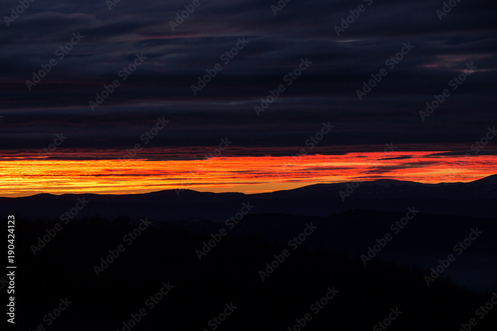 Glowing sky and dramatically colored clouds during sunset, view from Kopitoto Hill, Vitosha Mountain, Sofia, Bulgaria