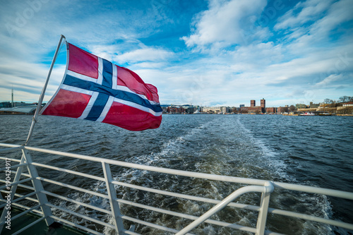 Norwegian flag on ship with Oslo in Norway in the background