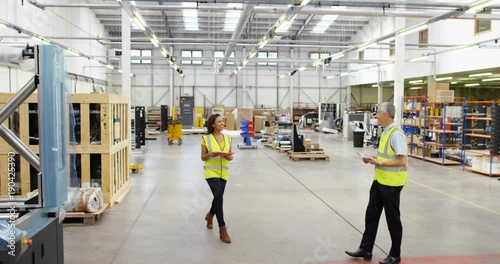 Wallpaper Mural 4k, Shot of two coworkers shake hands and inspect inventory in a distribution. SLow motion. Torontodigital.ca