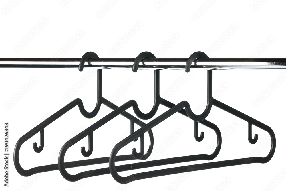 Three empty coat / clothes hangers on a clothes rail with a white background. Potential copy space above hangers. Three empty coat / clothes hangers on a clothes rail with a white background. Potential copy space above hangers.