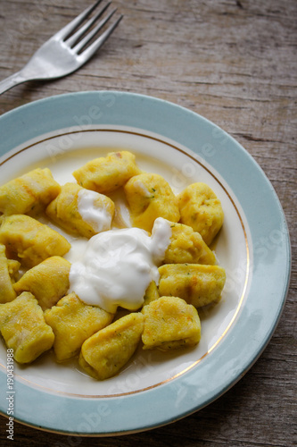 gnocchi in a plate on a wooden table