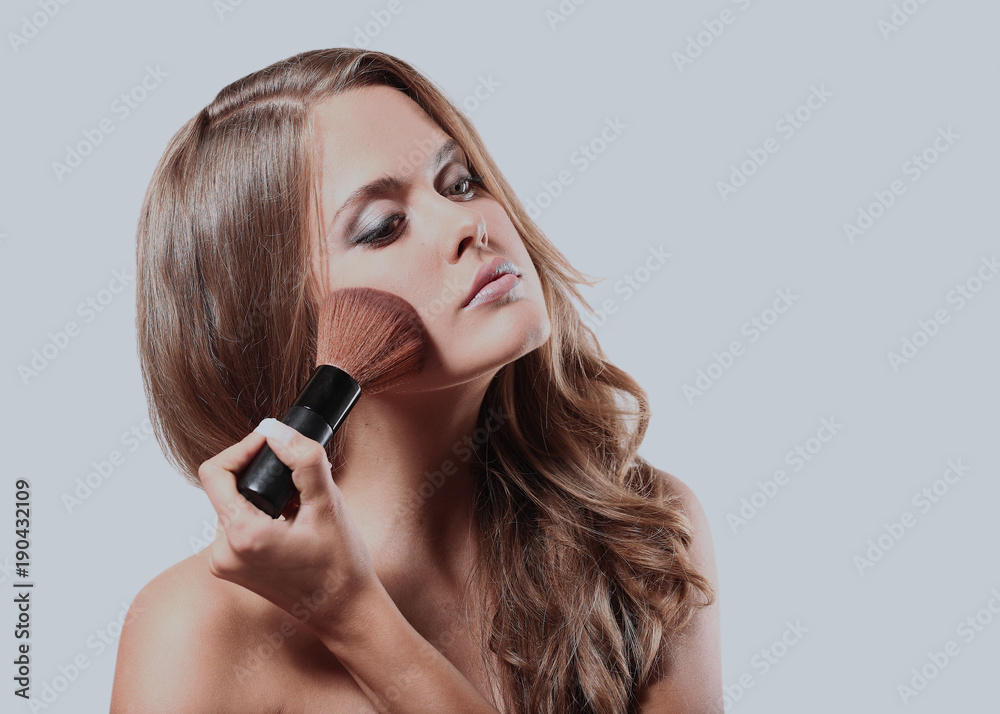 Beautiful woman with makeup brush. Beautiful woman with makeup brush.