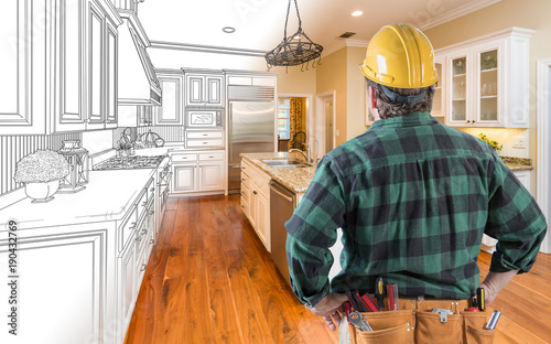 Male Contractor with Hard Hat and Tool Belt Looking At Custom Kitchen Drawing Photo Combination On White. photo