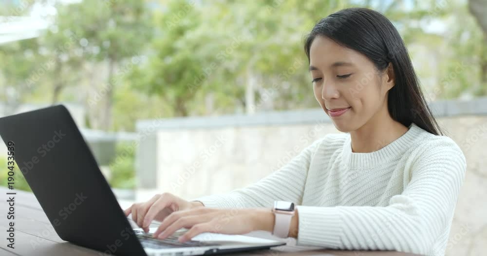 Woman working on laptop computer at outdoor Woman working on laptop computer at outdoor