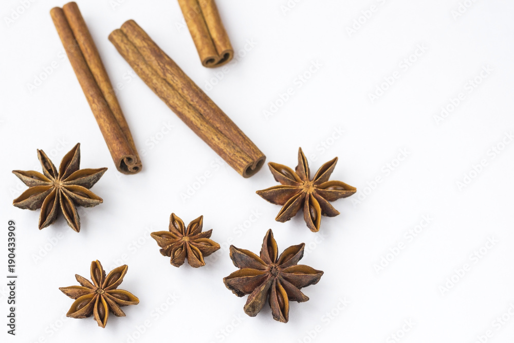 Spices: star anise and cinnamon sticks on white background. Close up. Spices: star anise and cinnamon sticks on white background. Close up.
