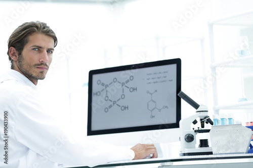 Medical doctor working with microscope in laboratory