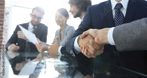 handshake of business partners in conference room