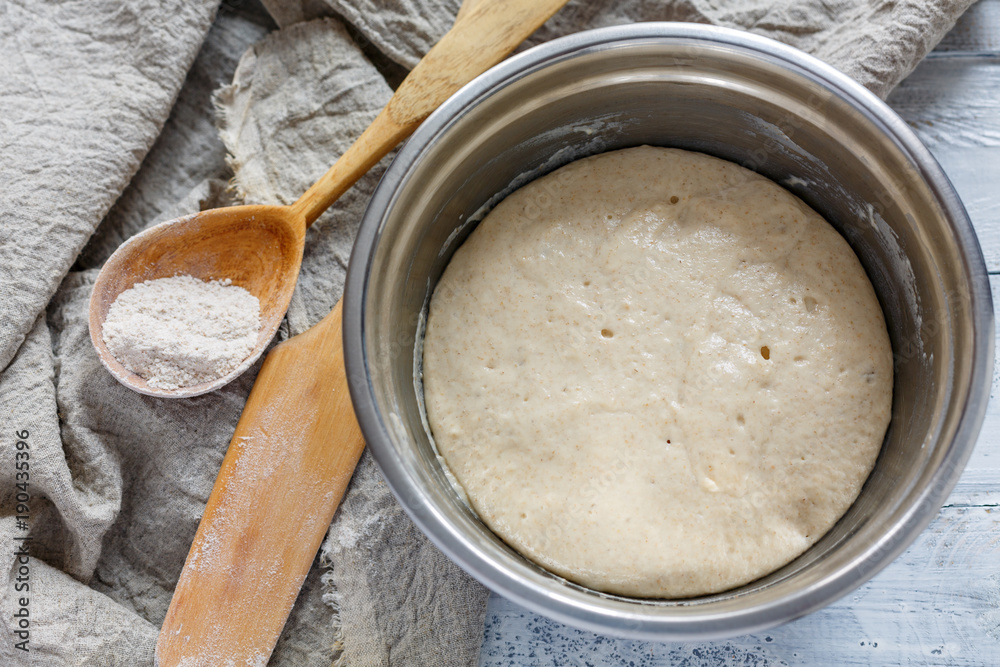 Leaven for the dough in a metal bowl. Leaven for the dough in a metal bowl.