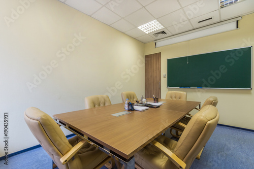 Interior of a modern office meeting room with coffe mashine