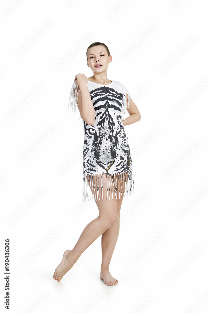 Fototapeta premium A young woman with bobbed hair in a dress with tiger print.