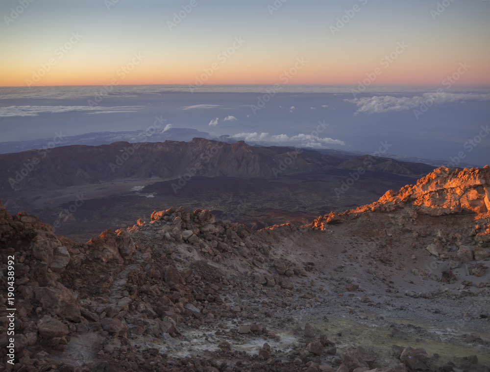 red glow before sunrise with vulcanic landscape from the top of pico del teide vulcano highest spanish mountain on tenerife canary island