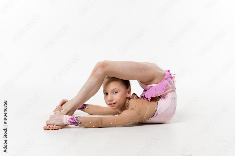 A Young Teenage Girl In Leotard Shows Gymnastic And Ballet Exercises On 