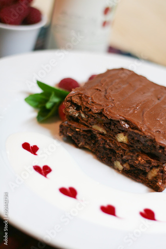 Stacked Chocolate brownie cake  raspberries  hearts  sauce  mint