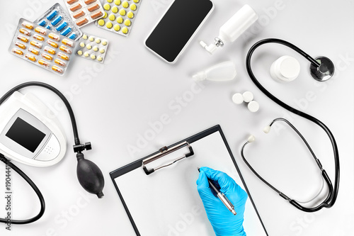 Doctor s table, tools, medical instruments, therapist tonometer, blood pressure, work in hospital on white background flat lay photo