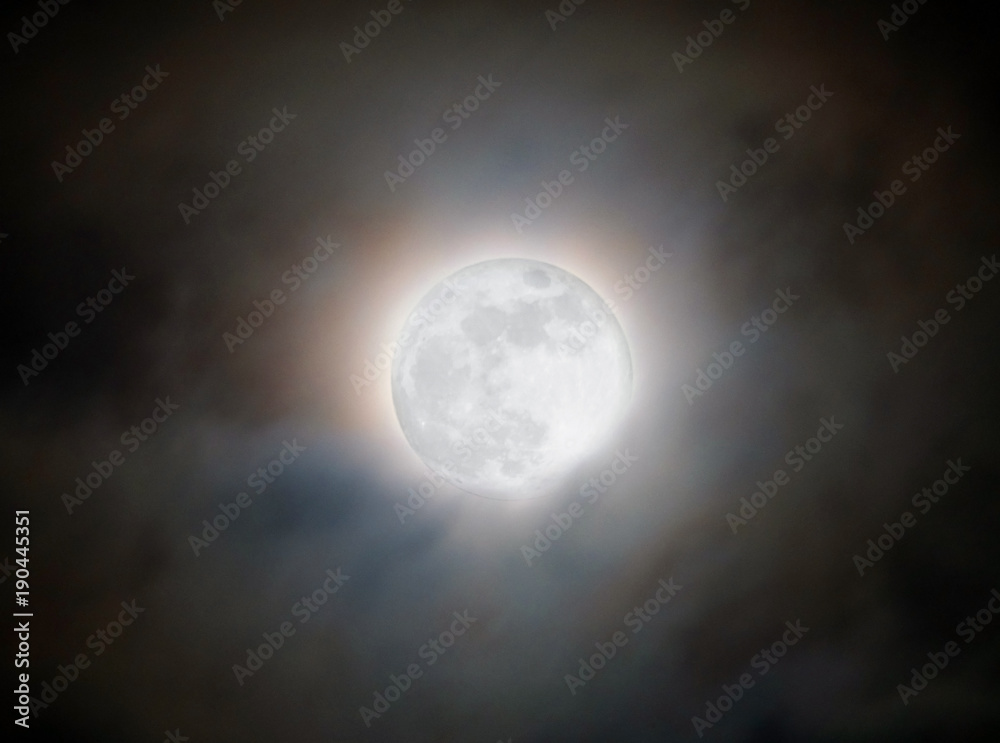 bright glowing moon though clouds on the night of the super blue moon january 31 2018 bright glowing moon though clouds on the night of the super blue moon january 31 2018