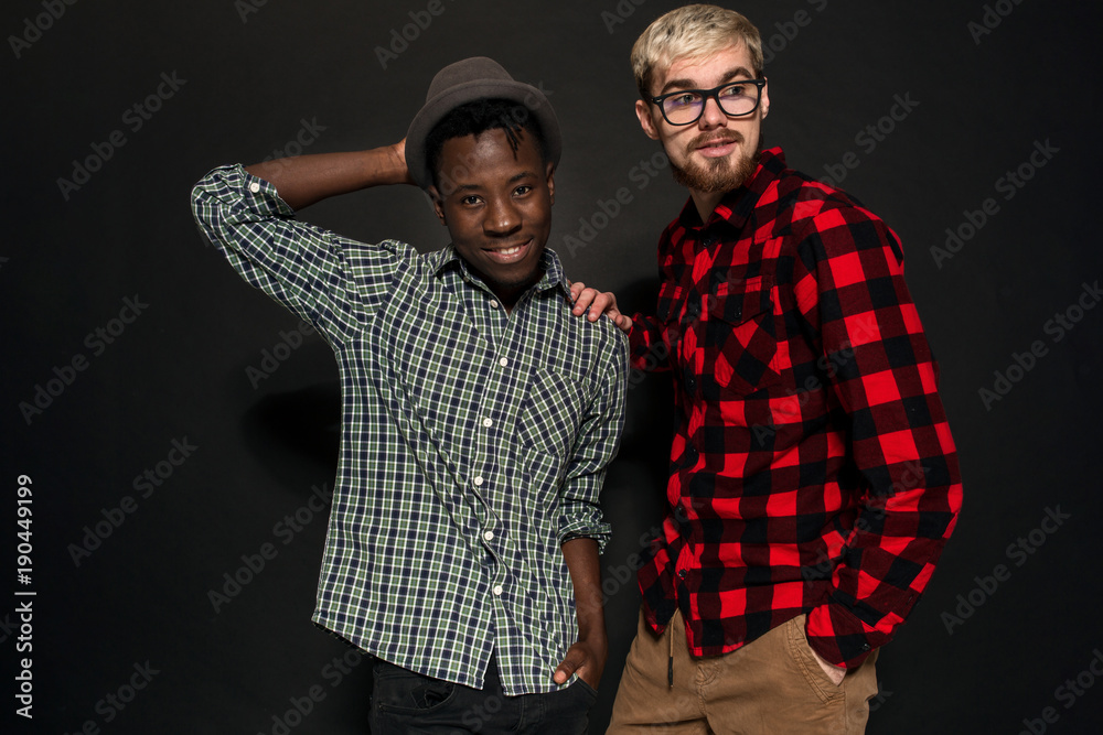 Studio lifestyle portrait of two best friends hipster boys going crazy and  having great time together. On black background. Stock Photo | Adobe Stock