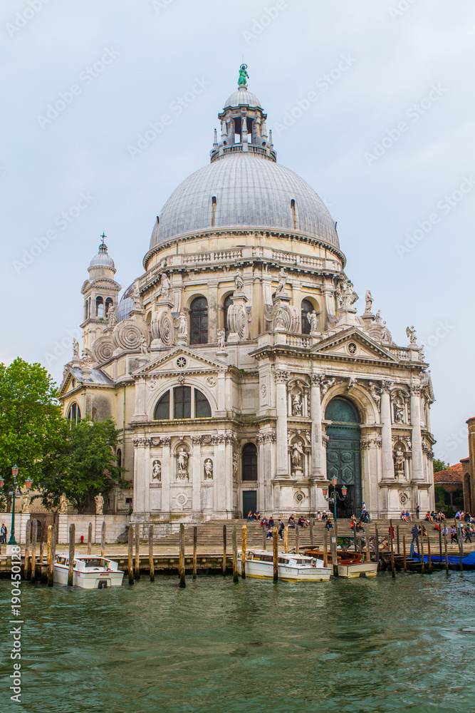 VENICE, ITALY - on May 5, 2016. View on Santa Maria della Salute church at sunrise.Tourists from all the world enjoy the historical city of Venezia in Italy, famous UNESCO World Heritage Site