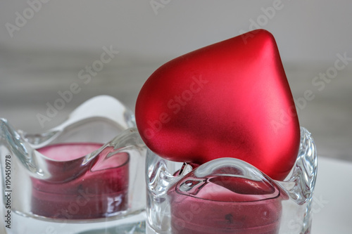 фотографія Single satin red heart sitting on a white background