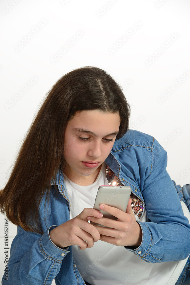 Young teenager connected to the internet with the cell phone. Young teenager connected to the internet with the cell phone.