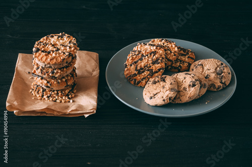 Chocolate chip cookies on dark old wooden table with place for text., freshly baked. Selective Focus with Copy space