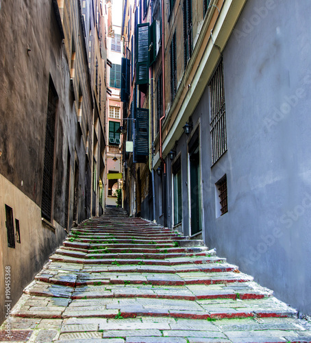 Fototapeta Naklejka Na Ścianę i Meble -  A narrow alley with stone staircase in the ancient center of Genoa, Italy.