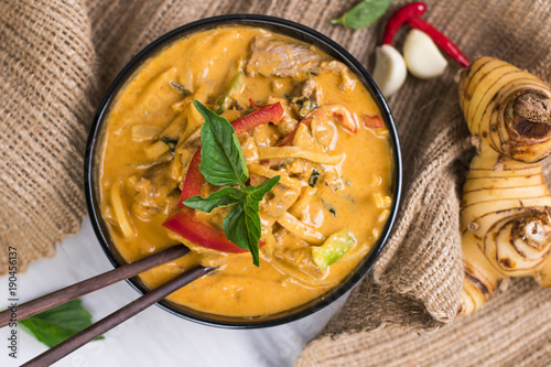 Chicken red curry in a black bowl