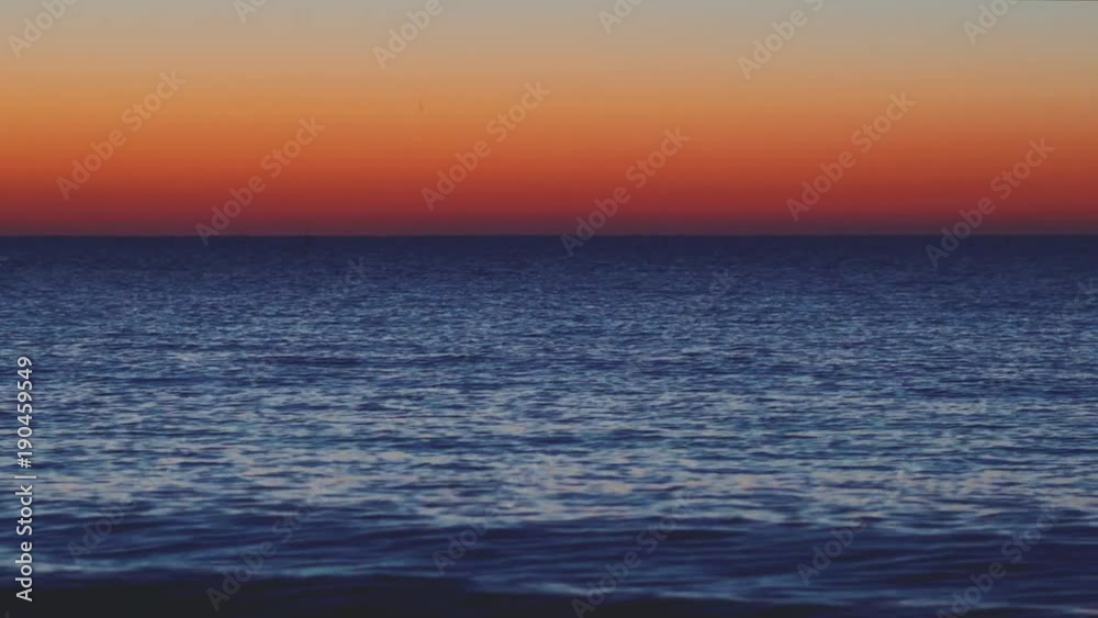 Sea coast in the background of a magical sunset. Waves on the water surface. Clean sea horizon. Texture of water and sky Sea coast in the background of a magical sunset. Waves on the water surface. Clean sea horizon. Texture of water and sky