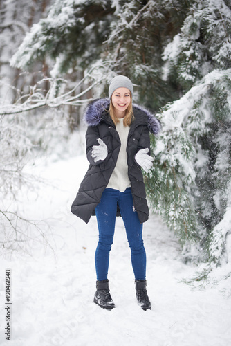 cheerful girl in a winter forest