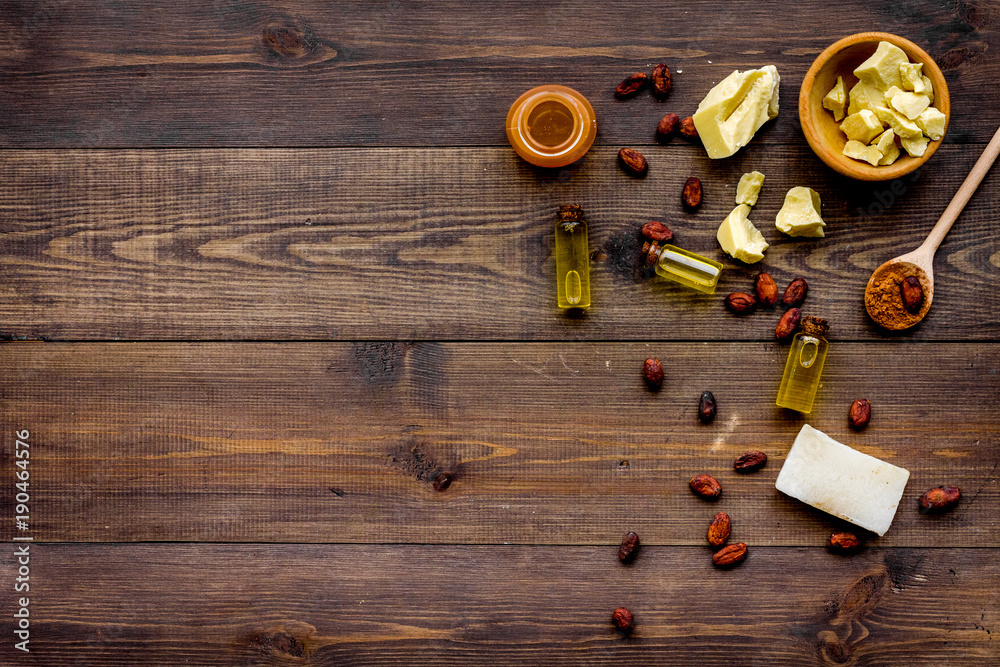 Homemade soap with cocoa butter. Cosmetics with natural ingredient. Dark wooden background top view space for text Homemade soap with cocoa butter. Cosmetics with natural ingredient. Dark wooden background top view space for text