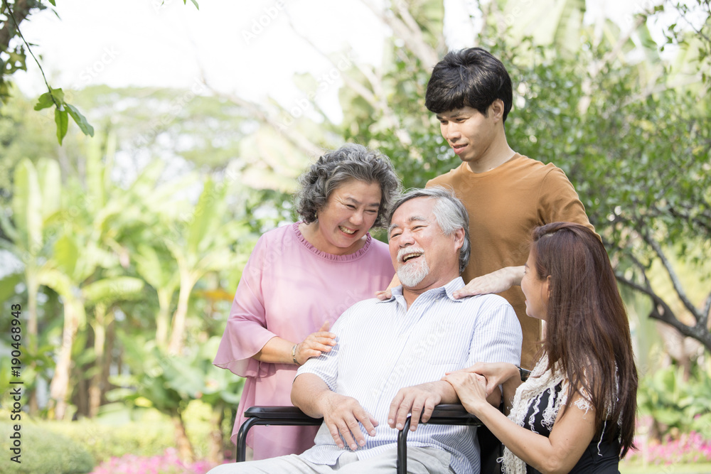 Portrait Of Asian Family Relaxing In Park Together. People lifestyle concept.