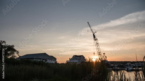 Day to night time lapse shot of crane at harbor photo