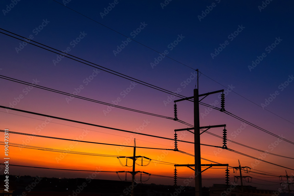 Electric lines at sunset evening twilight sky.