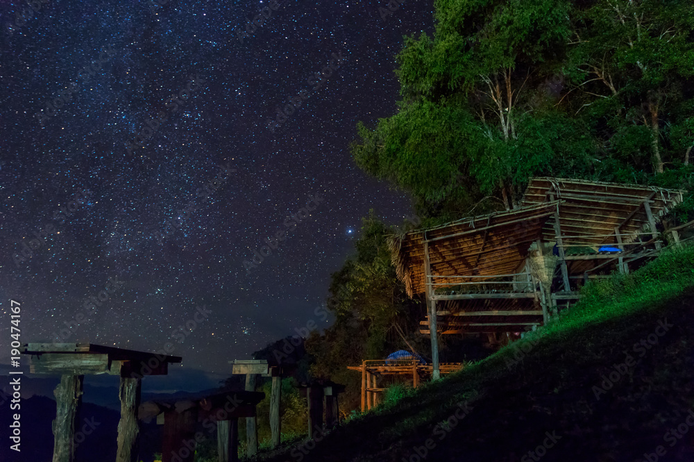 Huts and stars at night.